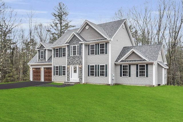 view of front of house with a front lawn and a garage