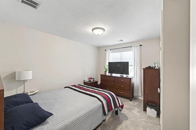 bedroom featuring light carpet