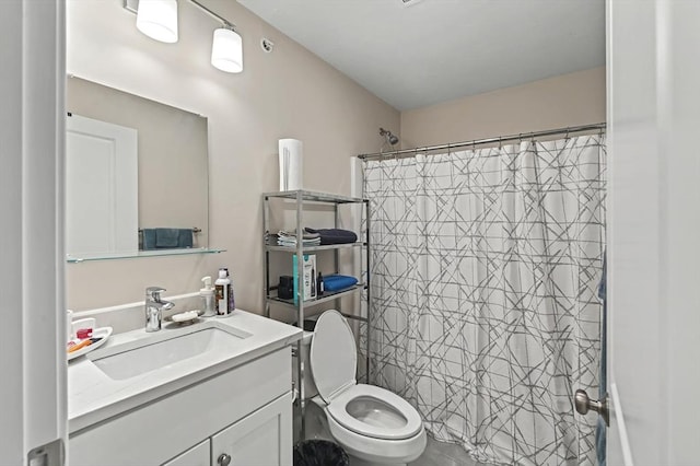 bathroom featuring vanity, curtained shower, and toilet