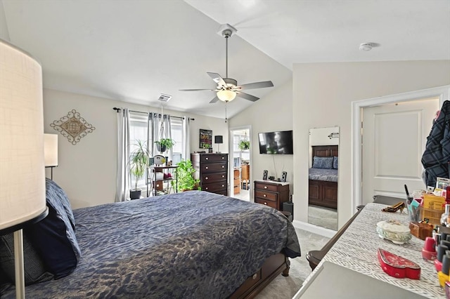 carpeted bedroom with ceiling fan, lofted ceiling, and ensuite bath