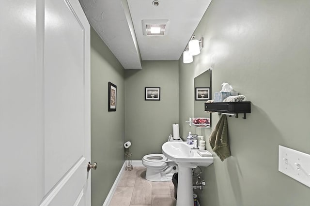 bathroom featuring tile patterned flooring and toilet