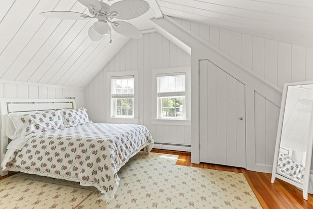 751 Crowell Rd, Chatham, MA 02650 - bedroom with wood finished floors, vaulted ceiling, a baseboard heating unit, and a ceiling fan