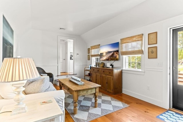 751 Crowell Rd, Chatham, MA 02650 - living room featuring vaulted ceiling, light wood-style floors, and baseboards