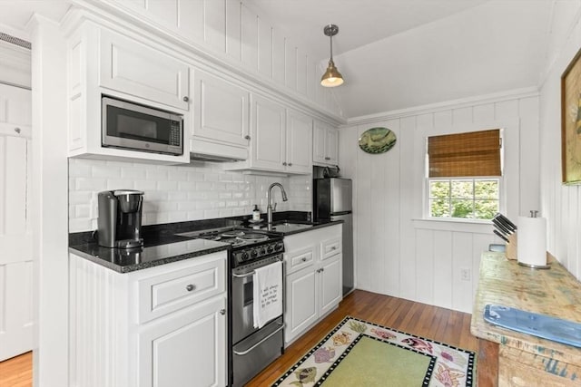 751 Crowell Rd, Chatham, MA 02650 - kitchen with appliances with stainless steel finishes, a sink, wood finished floors, and white cabinets