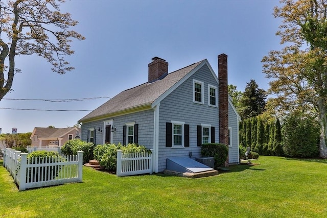 751 Crowell Rd, Chatham, MA 02650 - back of property featuring a chimney, cooling unit, and roof with shingles