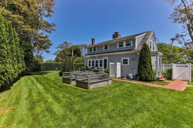 751 Crowell Rd, Chatham, MA 02650 - rear view of property with a vegetable garden, a chimney, and a gate