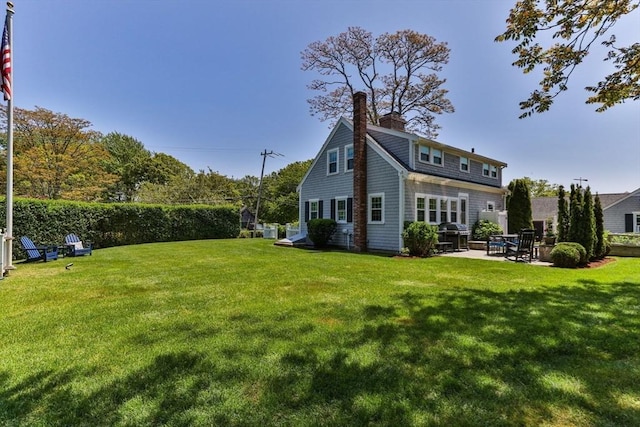 751 Crowell Rd, Chatham, MA 02650 - back of house featuring a patio area, a chimney, and a yard