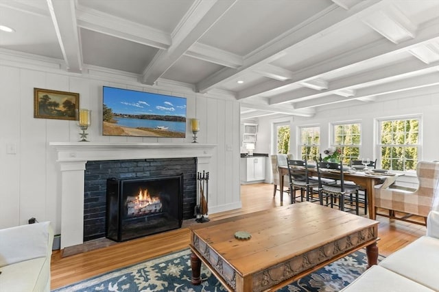 751 Crowell Rd, Chatham, MA 02650 - living area with light wood-style flooring, beamed ceiling, a brick fireplace, coffered ceiling, and a decorative wall