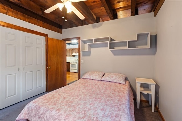 bedroom with carpet, beam ceiling, ceiling fan, and wooden ceiling