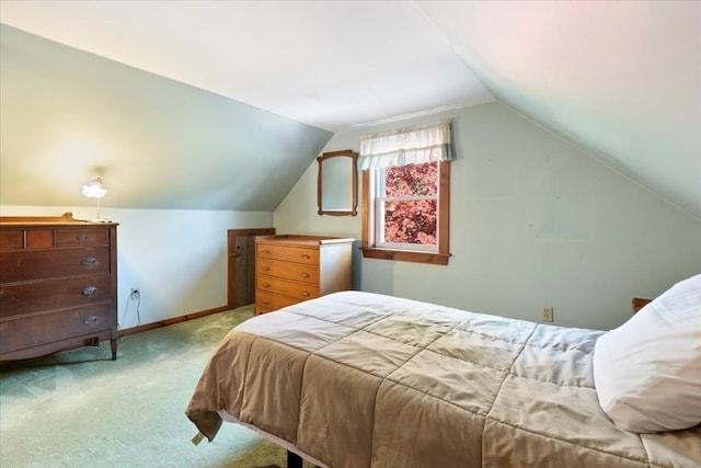 bedroom featuring lofted ceiling and light carpet