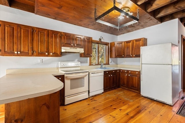 kitchen with kitchen peninsula, white appliances, sink, and light hardwood / wood-style floors