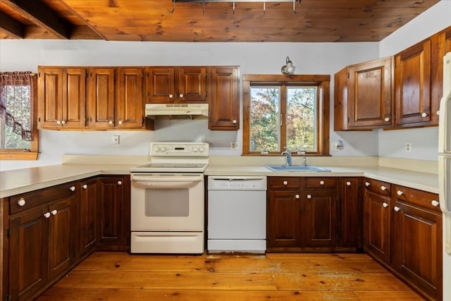 kitchen with beam ceiling, sink, light hardwood / wood-style floors, white appliances, and wooden ceiling