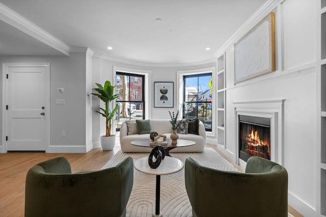 667 Tremont St Unit 1, Boston, MA 02118 - living area with ornamental molding, a lit fireplace, wood finished floors, baseboards, and built in features