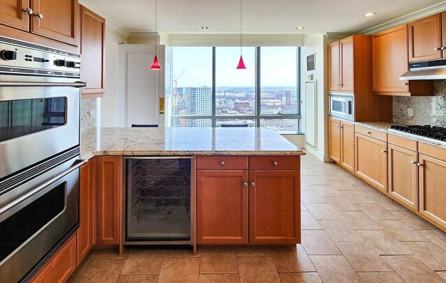 kitchen with tasteful backsplash, stainless steel microwave, wine cooler, under cabinet range hood, and a peninsula