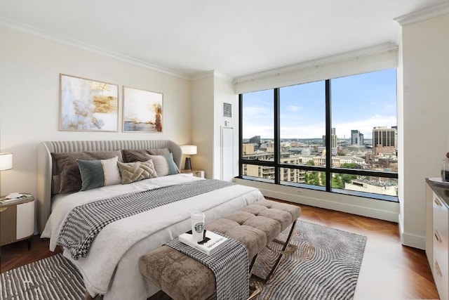 bedroom featuring a city view, crown molding, and visible vents