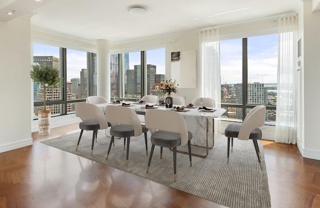 dining area with baseboards, plenty of natural light, and a city view