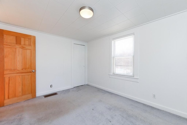 empty room featuring light colored carpet