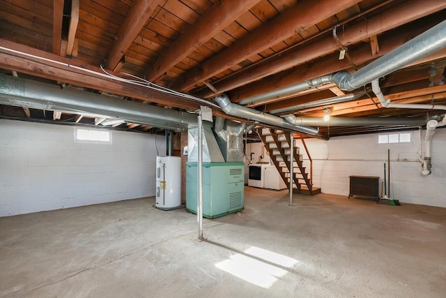 basement featuring heating unit, water heater, and washer and clothes dryer