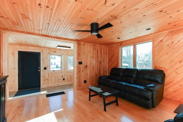 living room with ceiling fan, light hardwood / wood-style floors, wooden ceiling, and a healthy amount of sunlight