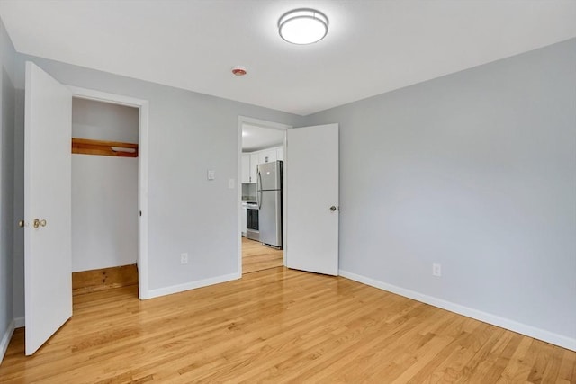 738 Piper Rd, West Springfield, MA 01089 - unfurnished bedroom featuring freestanding refrigerator, light wood finished floors, and a closet