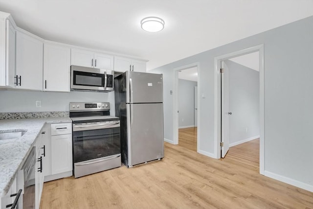 738 Piper Rd, West Springfield, MA 01089 - kitchen with stainless steel appliances, white cabinets, light wood-style floors, and light stone countertops