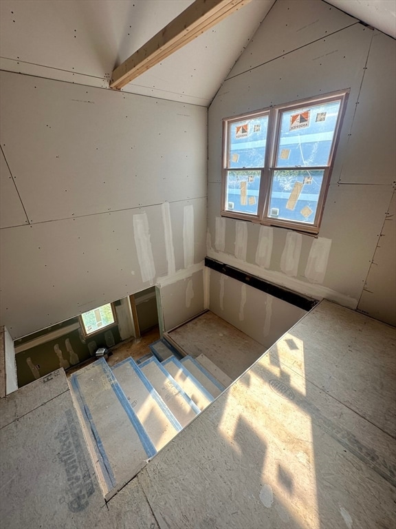 empty room featuring lofted ceiling