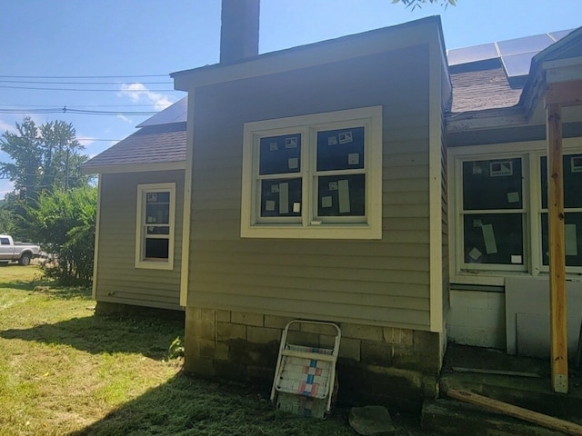 view of property exterior featuring a lawn