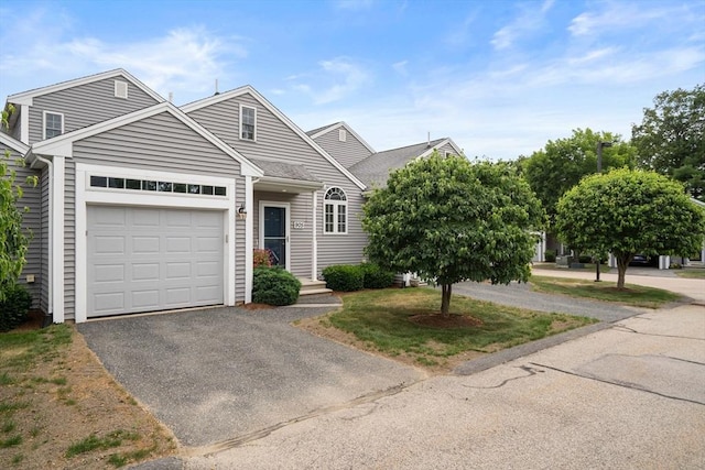 905 Village Ln Unit 905, Bellingham, MA 02019 - view of front facade with a garage, driveway, and a shingled roof