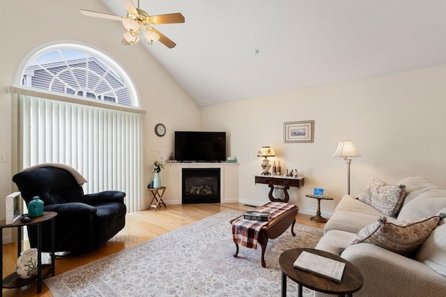 905 Village Ln Unit 905, Bellingham, MA 02019 - living room with high vaulted ceiling, wood finished floors, ceiling fan, and a glass covered fireplace