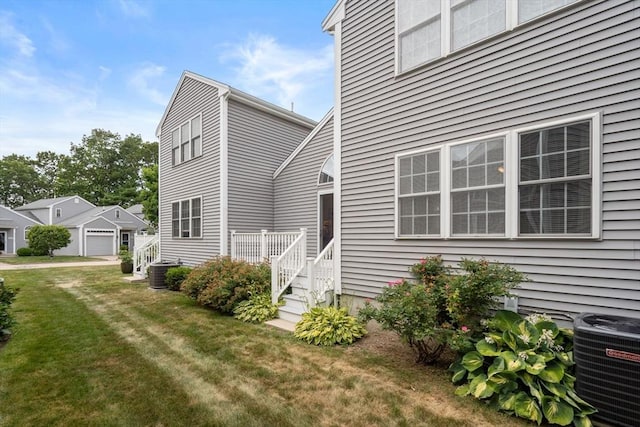 905 Village Ln Unit 905, Bellingham, MA 02019 - back of house featuring a lawn and a detached garage