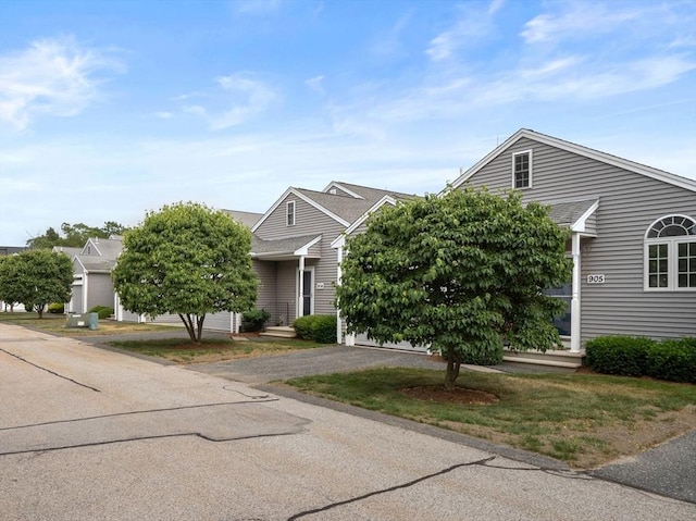 905 Village Ln Unit 905, Bellingham, MA 02019 - view of property hidden behind natural elements featuring asphalt driveway