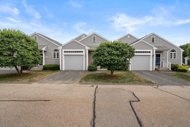 905 Village Ln Unit 905, Bellingham, MA 02019 - view of front of house featuring driveway and an attached garage