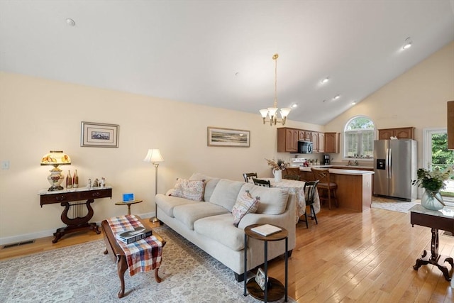 905 Village Ln Unit 905, Bellingham, MA 02019 - living area with light wood-type flooring, a chandelier, high vaulted ceiling, and recessed lighting
