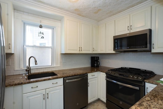 5 Clement Ave, Peabody, MA 01960 - kitchen featuring dishwashing machine, gas stove, stainless steel microwave, a sink, and backsplash