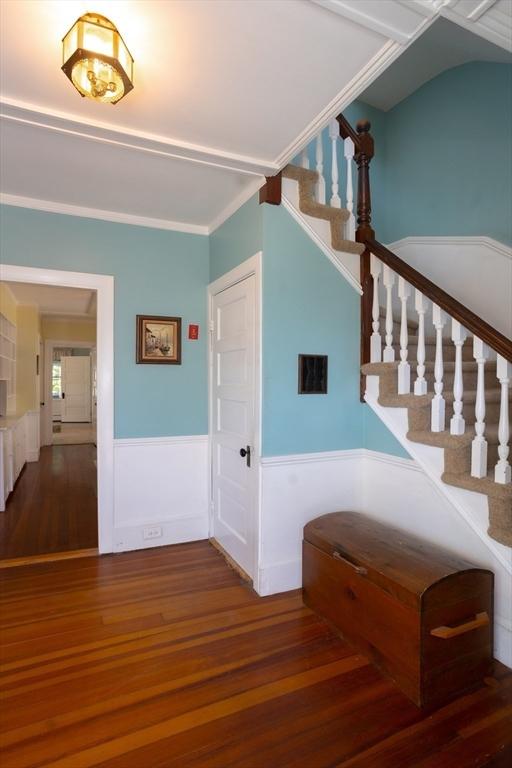 5 Clement Ave, Peabody, MA 01960 - staircase with wainscoting, wood finished floors, and ornamental molding