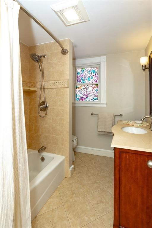5 Clement Ave, Peabody, MA 01960 - full bath featuring tile patterned flooring, vanity, toilet, shower / bath combo, and baseboards