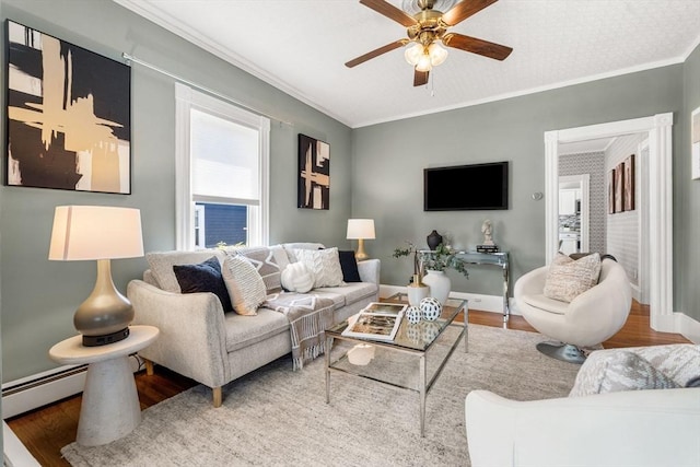24 Willard St, Malden, MA 02148 - living room with wood finished floors, ceiling fan, baseboard heating, and ornamental molding