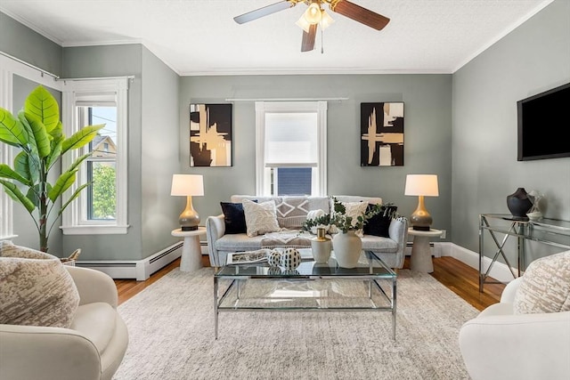 24 Willard St, Malden, MA 02148 - living room with wood finished floors, ornamental molding, and a ceiling fan