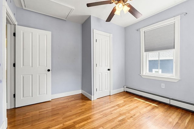 24 Willard St, Malden, MA 02148 - unfurnished bedroom with a baseboard radiator, light wood finished floors, a closet, and attic access