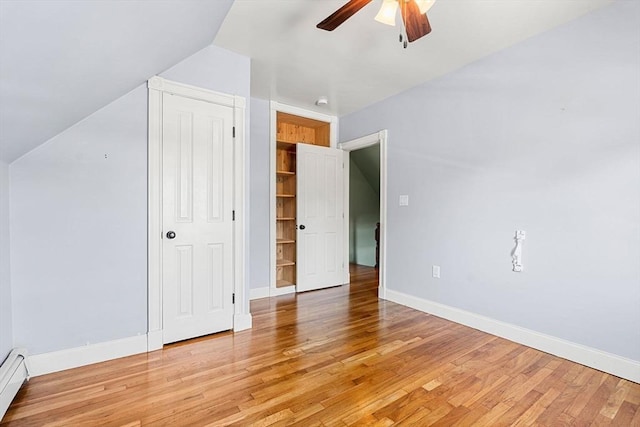 24 Willard St, Malden, MA 02148 - unfurnished bedroom with vaulted ceiling, light wood-type flooring, a baseboard heating unit, ceiling fan, and a closet
