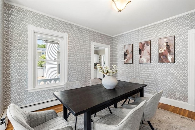 24 Willard St, Malden, MA 02148 - dining area with crown molding, wood finished floors, and a baseboard heating unit