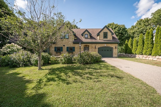 view of front facade with a garage and a front yard