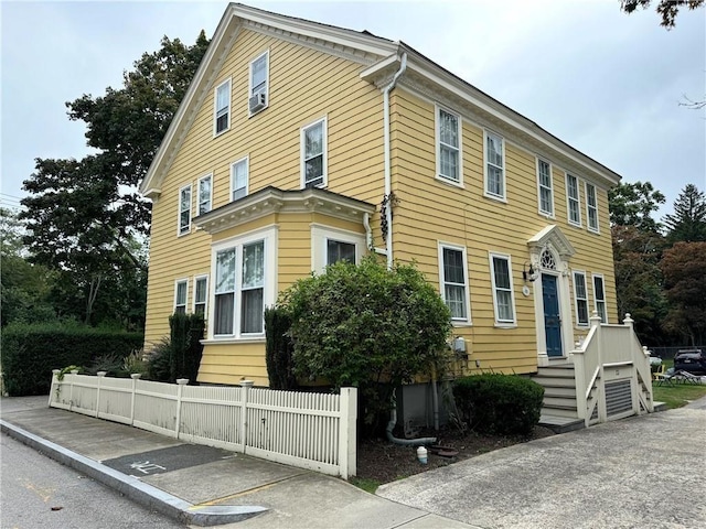 view of front of property featuring fence