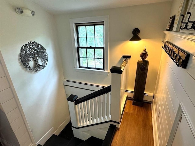 stairway featuring wood finished floors and baseboards