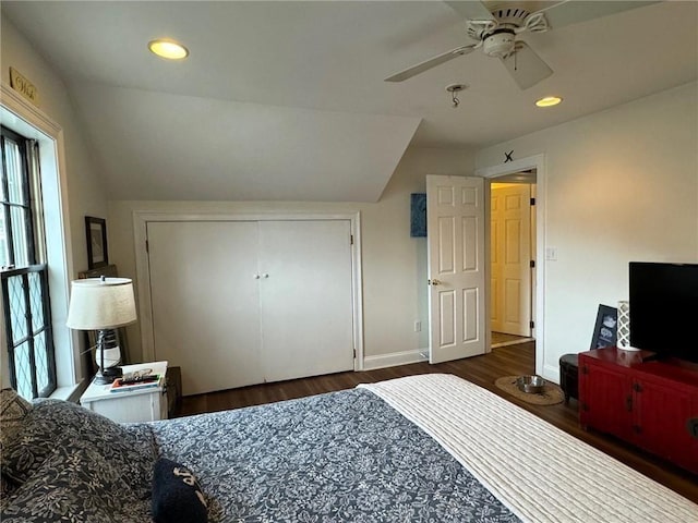 bedroom with baseboards, lofted ceiling, wood finished floors, a closet, and recessed lighting