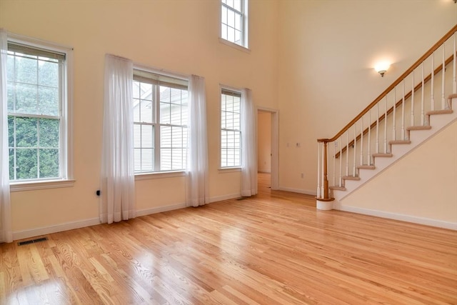 12 Braeburn Ln Unit 12, Ashland, MA 01721 - foyer featuring wood finished floors, stairway, and a high ceiling