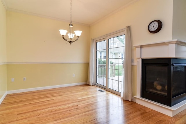 12 Braeburn Ln Unit 12, Ashland, MA 01721 - unfurnished living room featuring a chandelier, light wood-type flooring, a multi sided fireplace, and crown molding