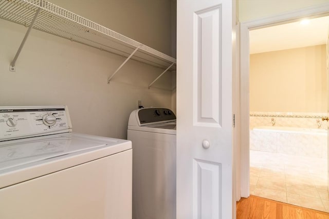 12 Braeburn Ln Unit 12, Ashland, MA 01721 - laundry area featuring washing machine and dryer and light wood finished floors