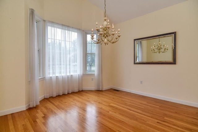 12 Braeburn Ln Unit 12, Ashland, MA 01721 - spare room featuring a chandelier, wood finished floors, and high vaulted ceiling