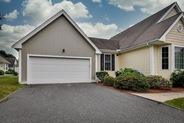 12 Braeburn Ln Unit 12, Ashland, MA 01721 - ranch-style house featuring asphalt driveway, an attached garage, and roof with shingles